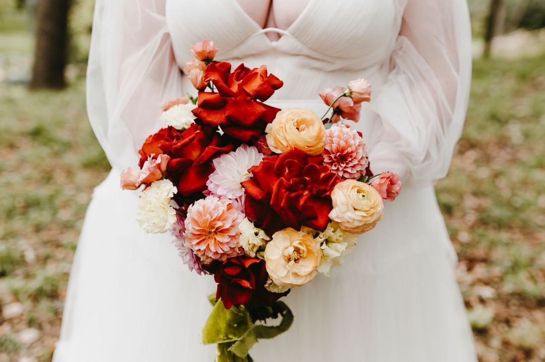 Bride holding custom bridal bouquet designed at In Flower shop in Sioux Falls, SD