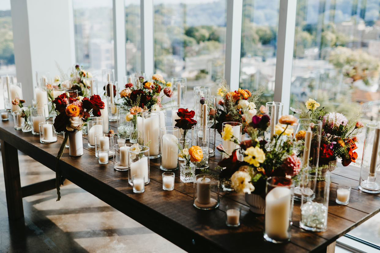 small wedding centerpieces on a table with flowers by In Flower, flower shop in Sioux Falls, SD