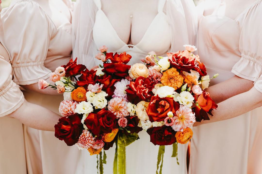 Bridesmaids holding custom bridesmaid bouquet designed at In Flower shop in Sioux Falls, SD